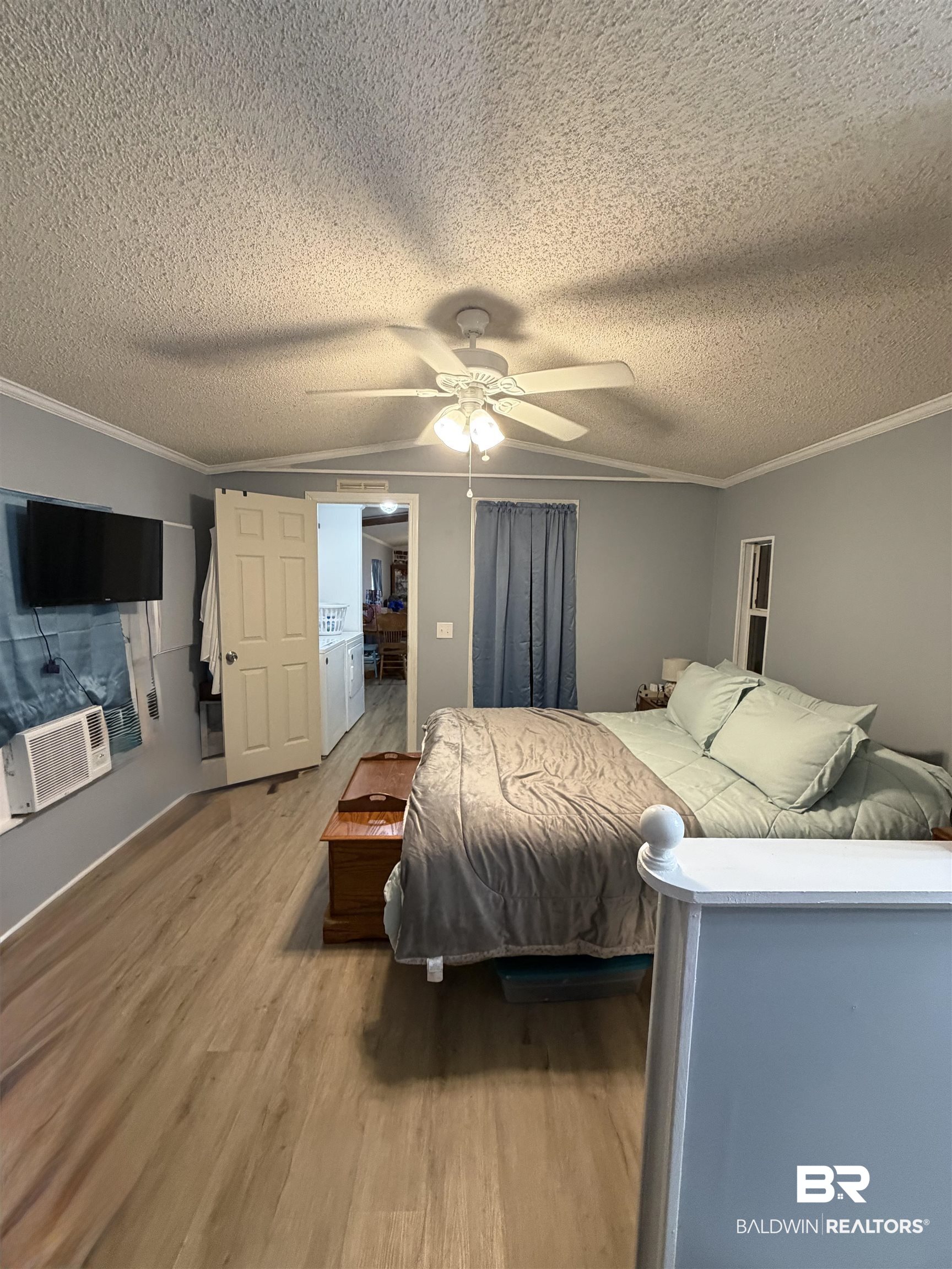 1913 Maria Lane Lillian, AL 36549 - Photo 10 of 35 Bedroom with ornamental molding, wood finished floors, ceiling fan, vaulted ceiling, and a textured ceiling
