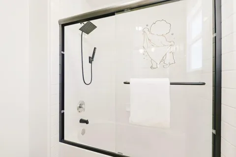 a bathroom with a glass shower door