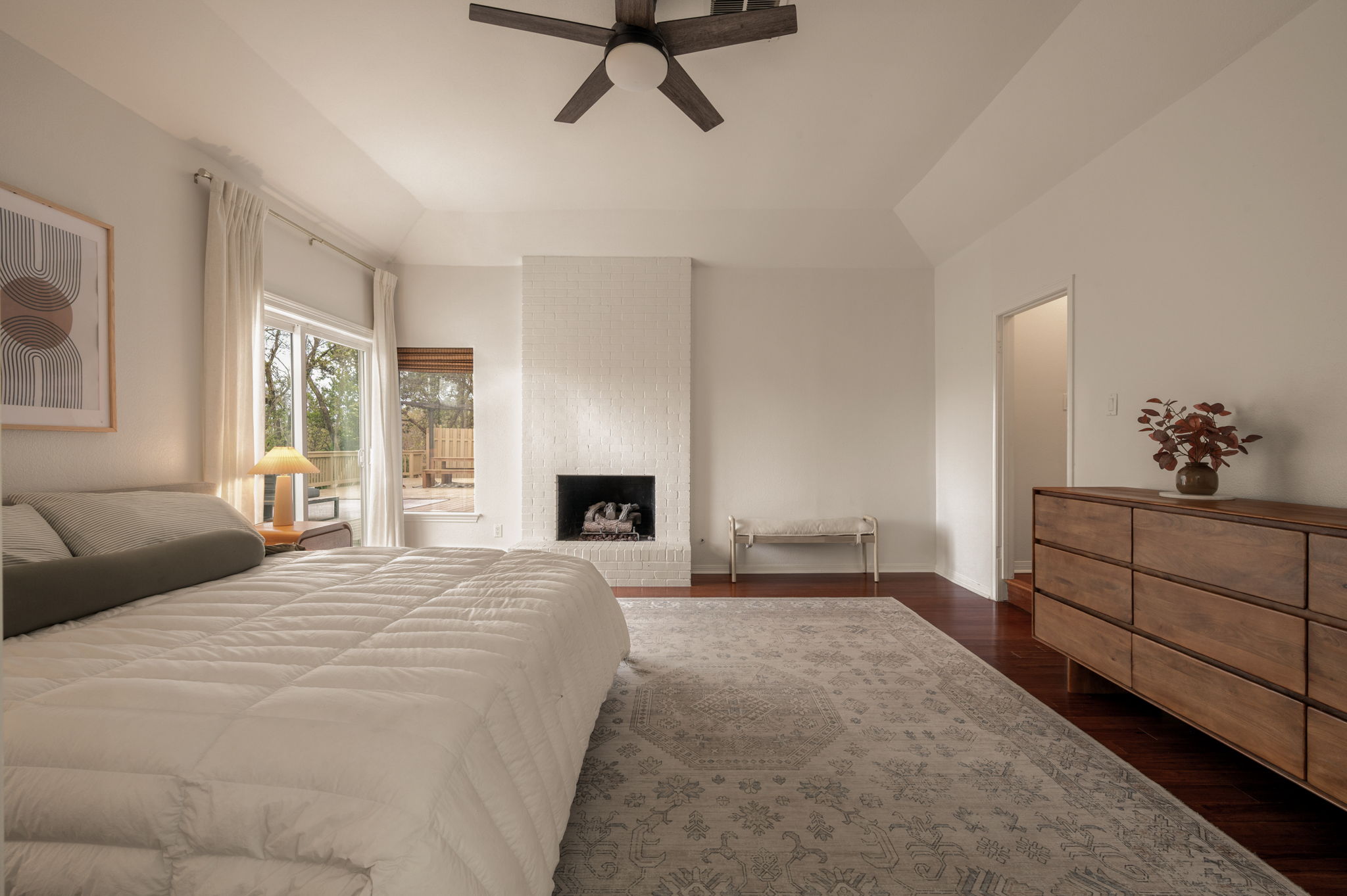 6501 Sumac Drive Austin, TX 78731 - Photo 13 of 40 Bedroom with dark wood-type flooring, ceiling fan, and a fireplace