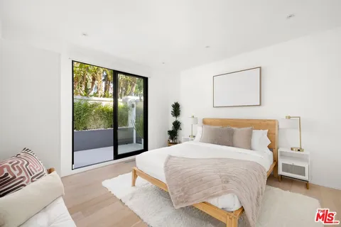 a bedroom with a large bed and a large window