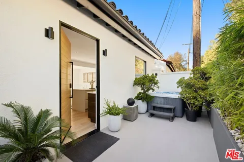 a house with potted plants in front of it