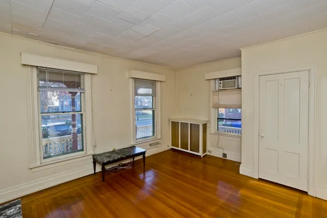 a view of a hallway with wooden floor and closet