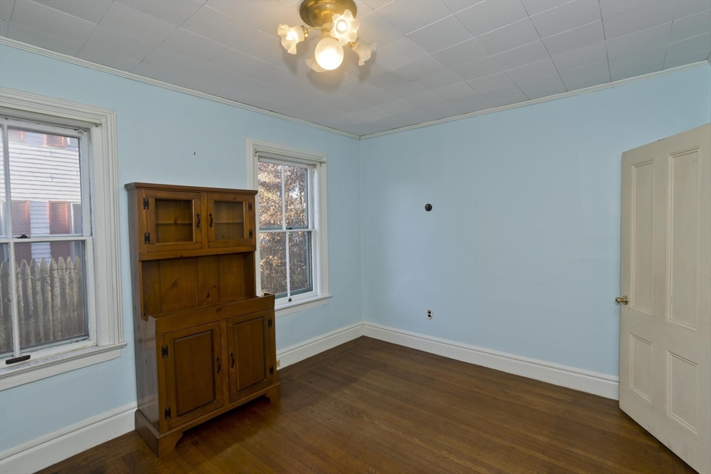 115 Thompson Street Springfield, MA 01109 - Photo 16 of 39 an empty room with wooden floor cabinet and windows