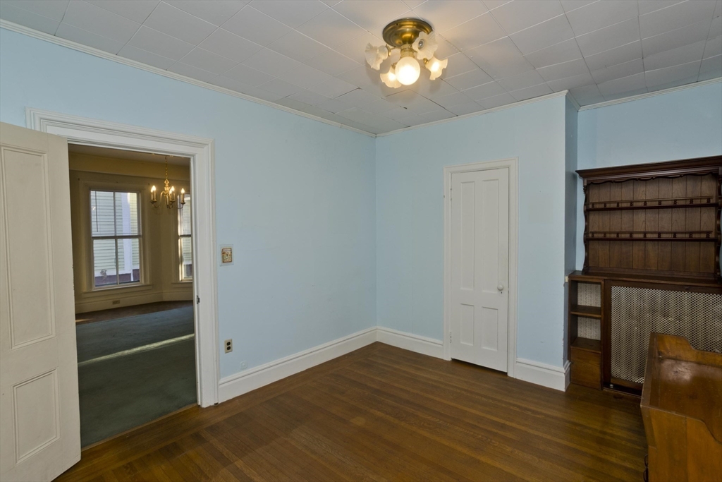 115 Thompson Street Springfield, MA 01109 - Photo 17 of 39 an empty room with wooden floor closet and windows