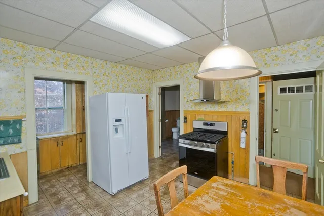 a kitchen with stainless steel appliances granite countertop a refrigerator a sink and a stove