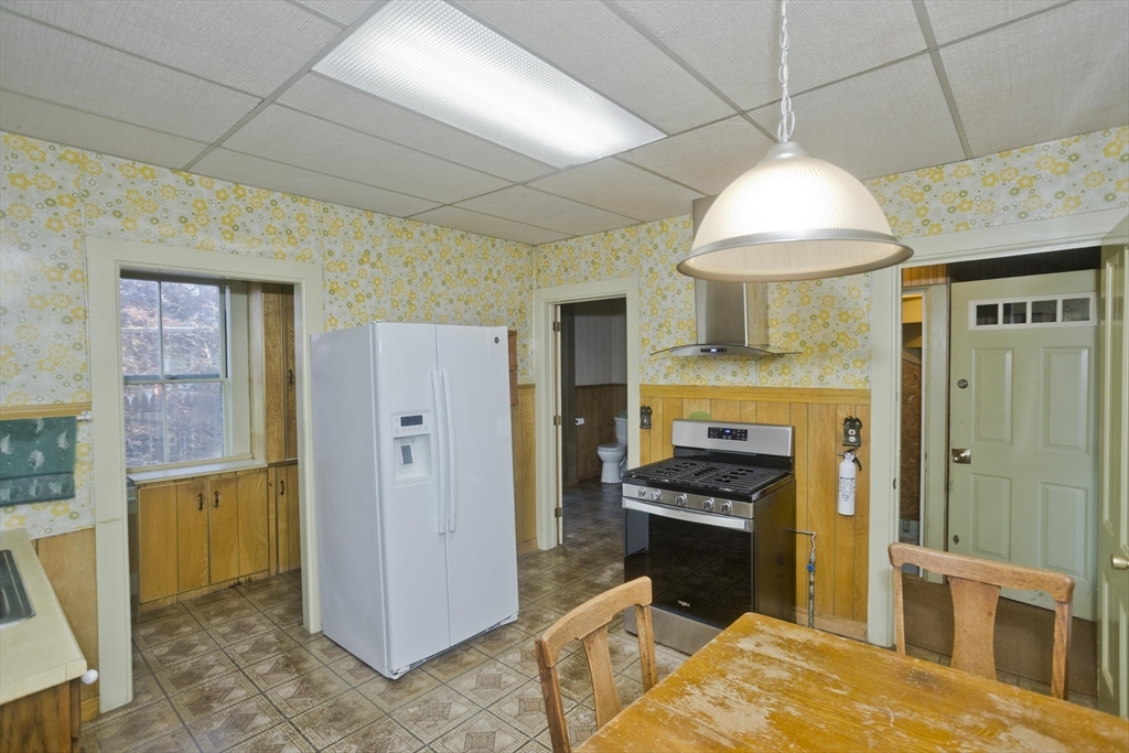 115 Thompson Street Springfield, MA 01109 - Photo 18 of 39 a kitchen with a refrigerator a stove and a cabinets