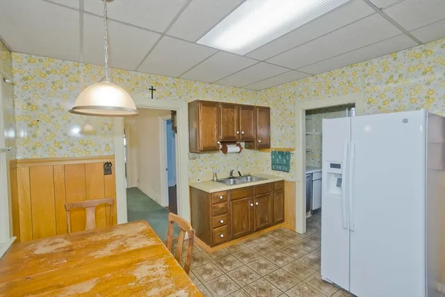 a kitchen with a refrigerator sink and cabinets
