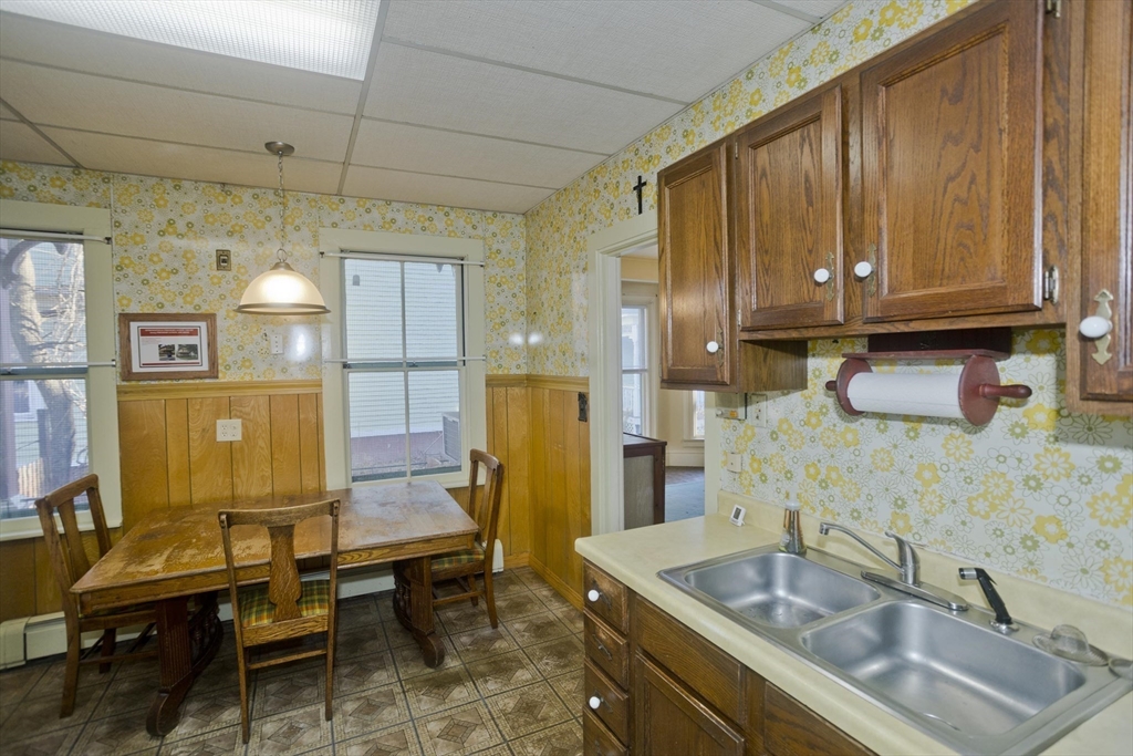 115 Thompson Street Springfield, MA 01109 - Photo 21 of 39 a kitchen with stainless steel appliances granite countertop a sink refrigerator and cabinets