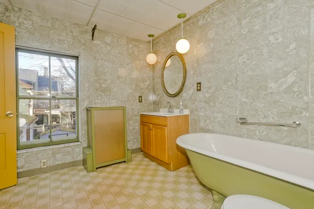 a bathroom with a sink mirror and tub