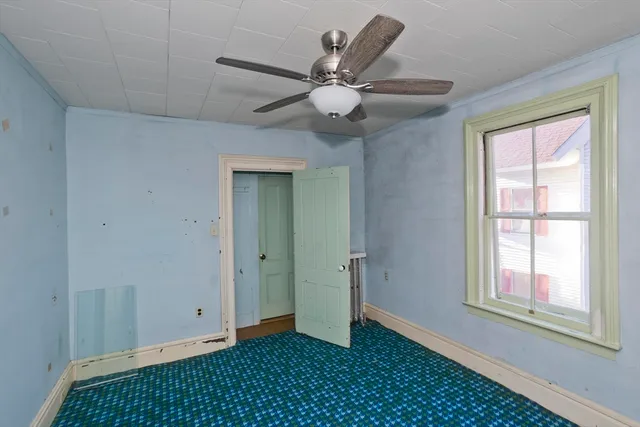 a view of a room with wooden floor and a window