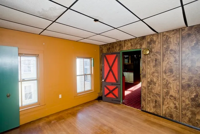 a view of a room with wooden floor