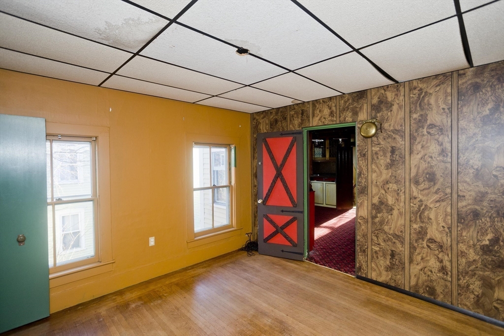 115 Thompson Street Springfield, MA 01109 - Photo 35 of 39 a view of an empty room with wooden floor and a window