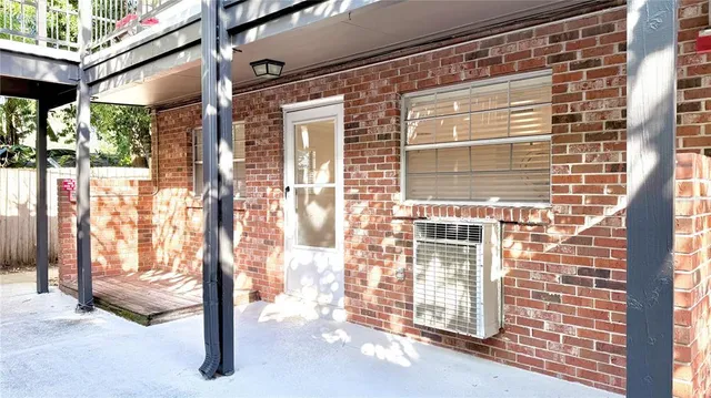 a view of a brick house with a large window