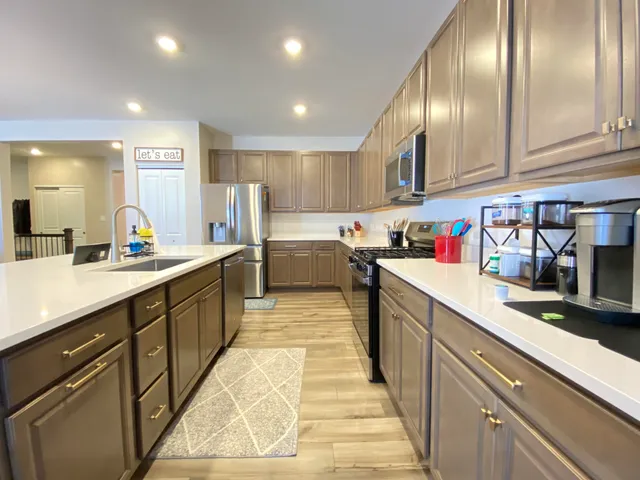 a kitchen with counter top space cabinets and stainless steel appliances