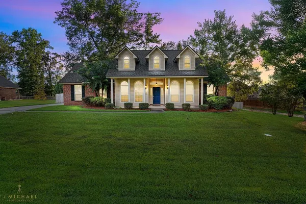 a front view of a house with a garden