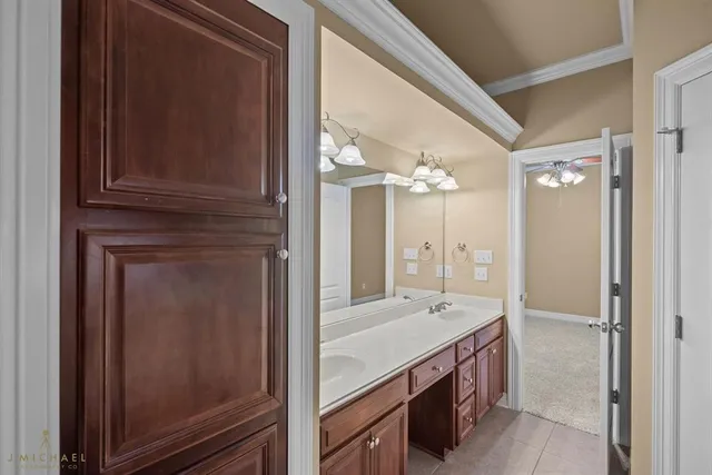 a bathroom with a granite countertop sink a mirror and a shower