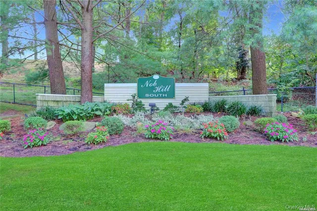 a view of a garden with flowers and trees