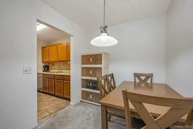 a view of kitchen with sink dining table and chairs