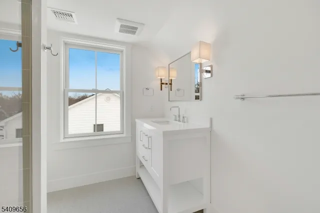a view of hallway with wooden floor and windows