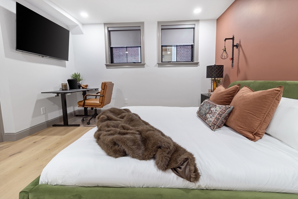 4 Snelling Place, Unit 4 Boston, MA 02113 - Photo 8 of 15 a bedroom with a bed window and a flat screen tv