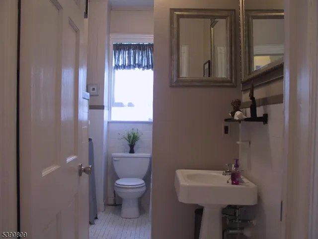 a bathroom with a sink a toilet and mirror