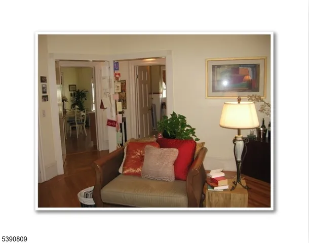 a living room with furniture and a mirror