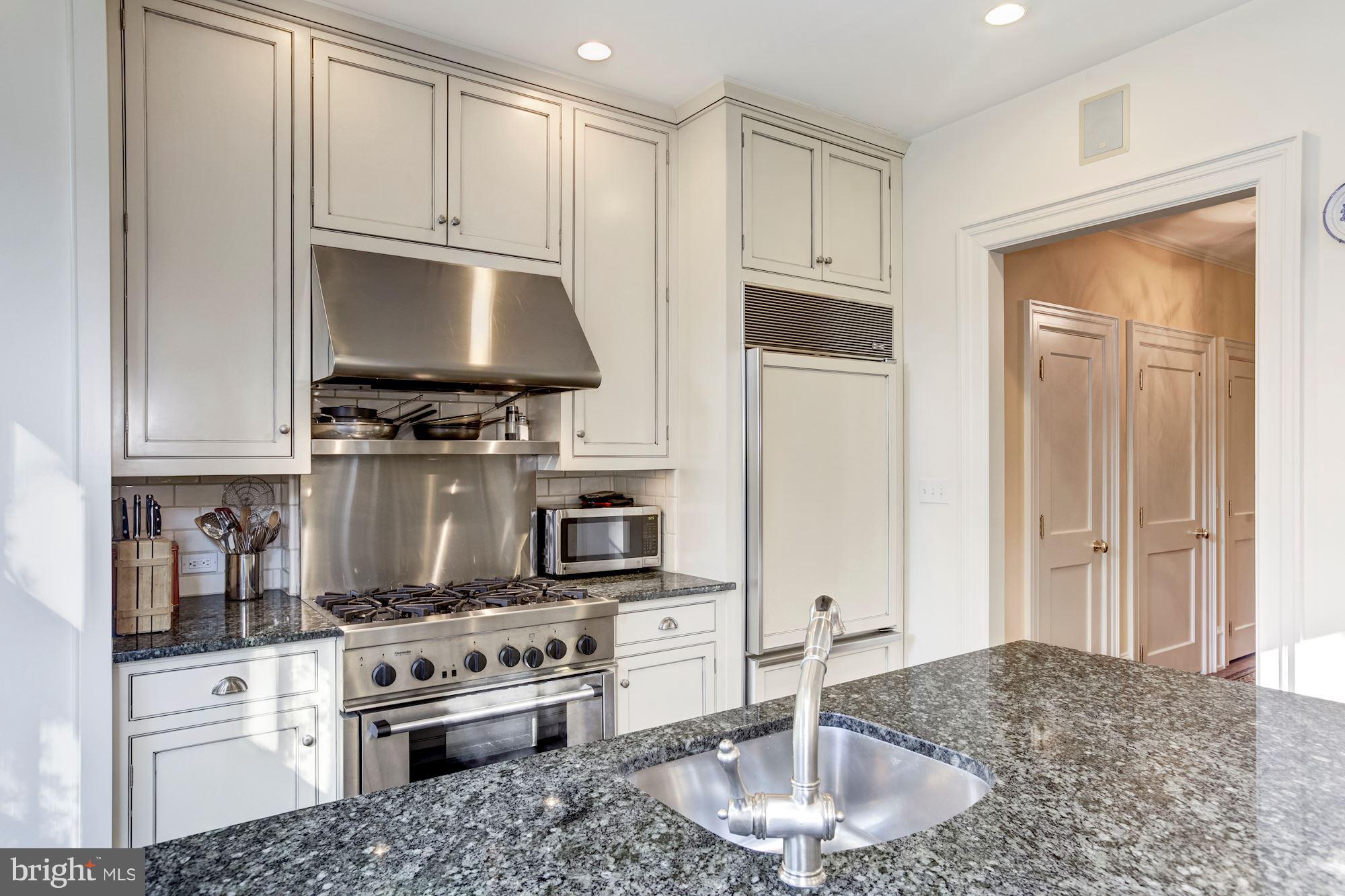 2326 California Street Northwest Washington, DC 20008 - Photo 11 of 30 a kitchen with stainless steel appliances granite countertop a stove a sink and a refrigerator
