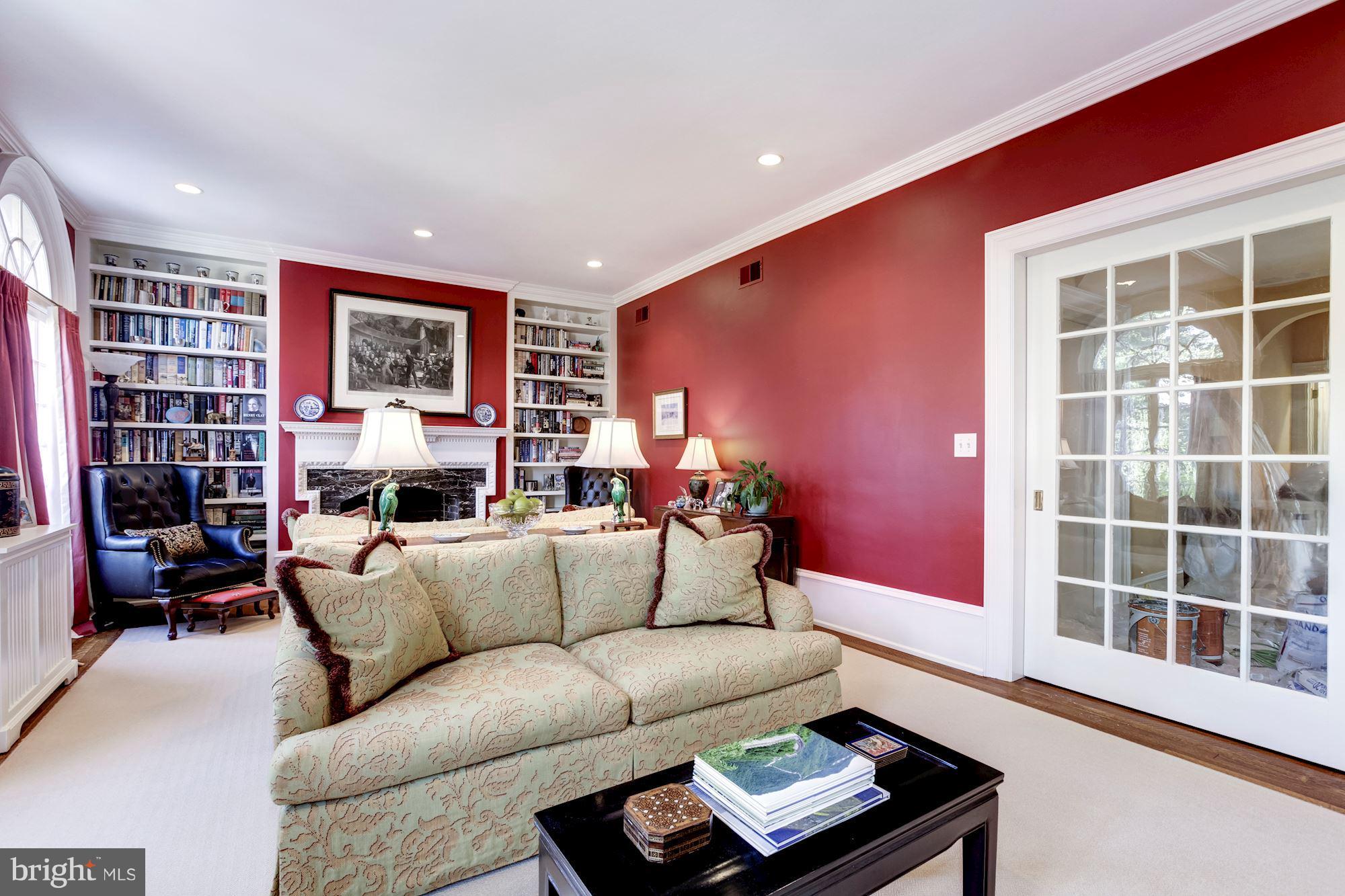 2326 California Street Northwest Washington, DC 20008 - Photo 17 of 30 a living room with furniture a bookshelf and a window