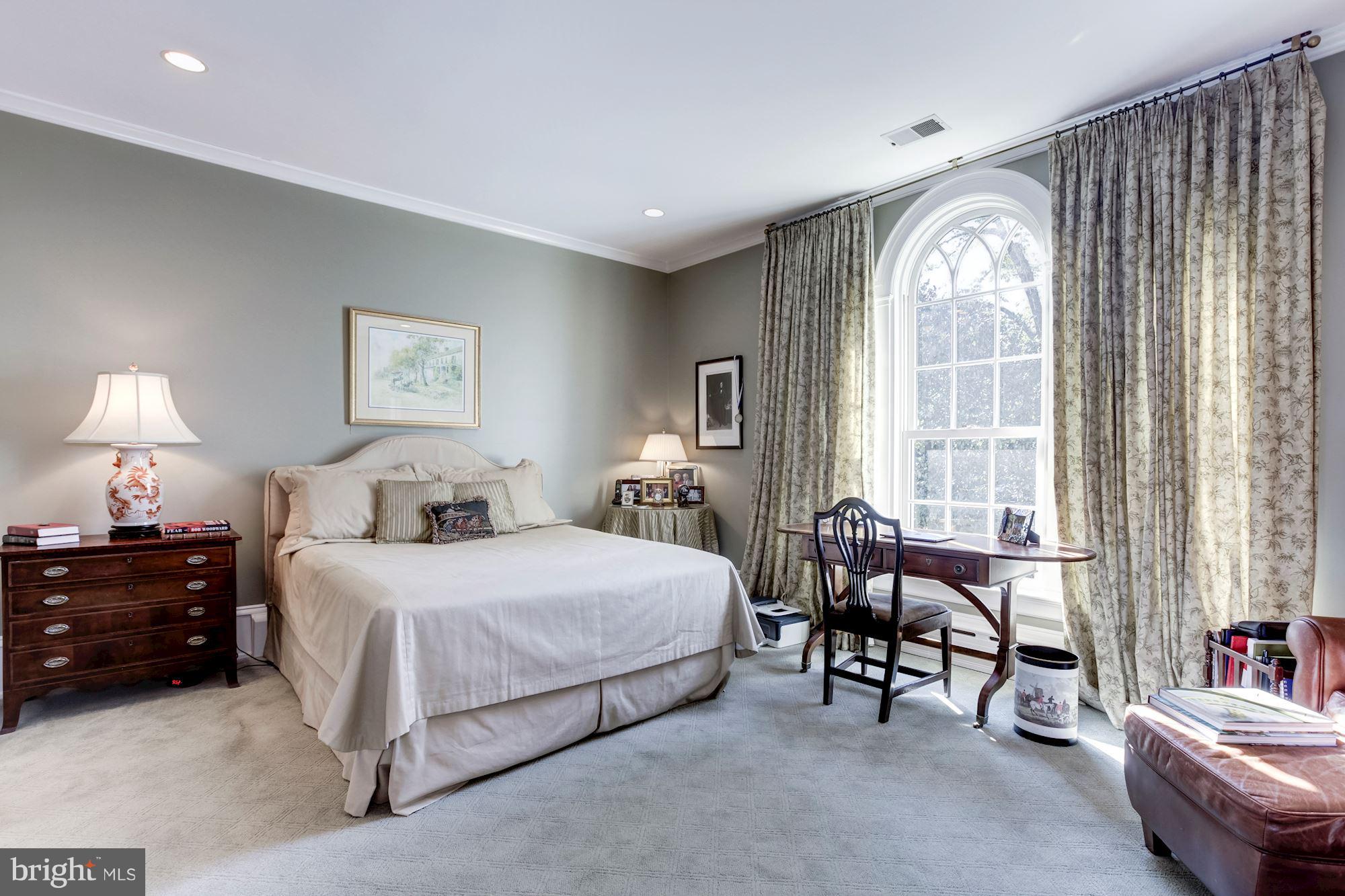 2326 California Street Northwest Washington, DC 20008 - Photo 18 of 30 a bedroom with a bed and a chandelier