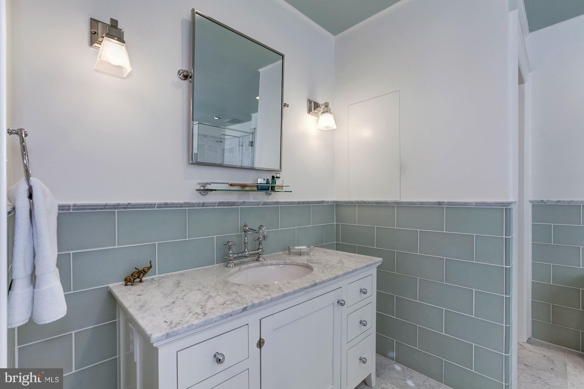 2326 California Street Northwest Washington, DC 20008 - Photo 21 of 30 a bathroom with a granite countertop sink a mirror and a