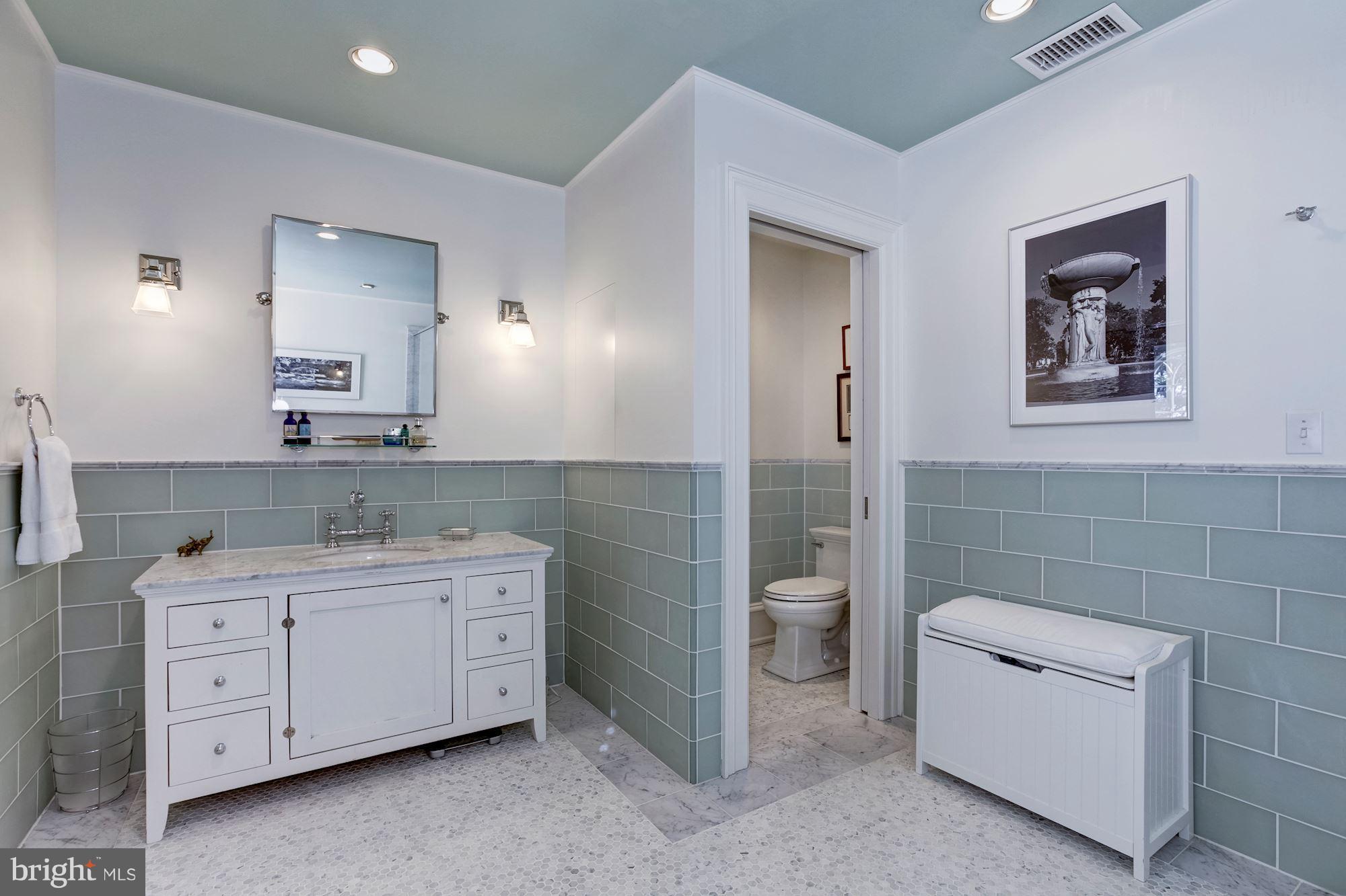2326 California Street Northwest Washington, DC 20008 - Photo 22 of 30 a bathroom with a double vanity sink a toilet a and mirror