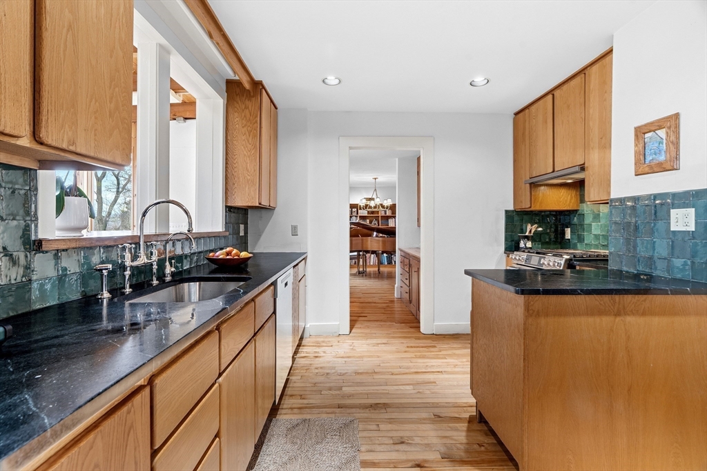61 Huntington Road Newton, MA 02458 - Photo 16 of 41 a kitchen with stainless steel appliances granite countertop a stove a sink and a microwave
