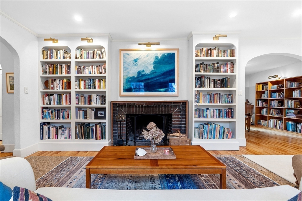 61 Huntington Road Newton, MA 02458 - Photo 2 of 41 a living room with bookshelf and a fireplace