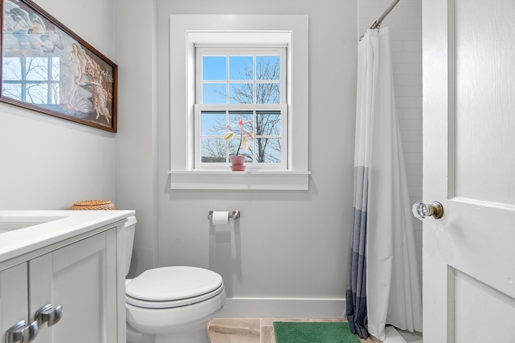 61 Huntington Road Newton, MA 02458 - Photo 26 of 41 a bathroom with a toilet a sink and a window