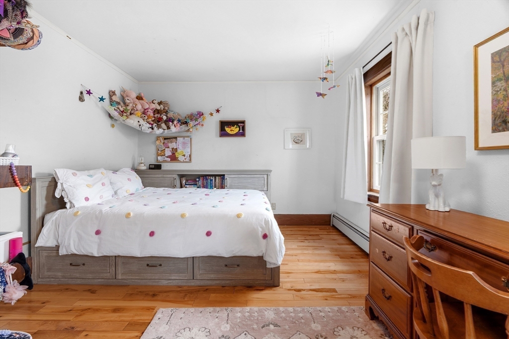 61 Huntington Road Newton, MA 02458 - Photo 28 of 41 a bedroom with a bed and wooden floor