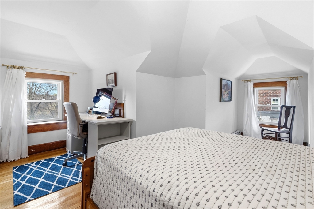 61 Huntington Road Newton, MA 02458 - Photo 33 of 41 a bedroom with a bed and wooden floor