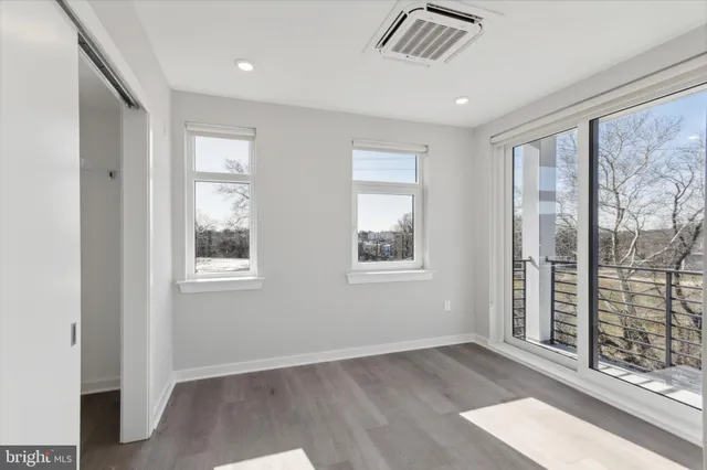 a view of an empty room with glass door and balcony