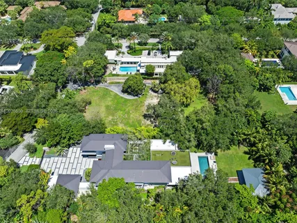 an aerial view of multiple houses with yard