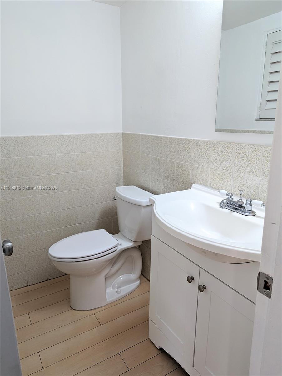 201 Galen Drive, Unit 215W Key Biscayne, FL 33149 - Photo 8 of 18 a bathroom with a sink a toilet and mirror