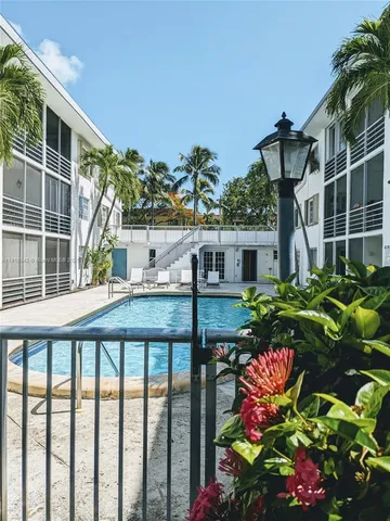 a front view of a house with a yard and fountain