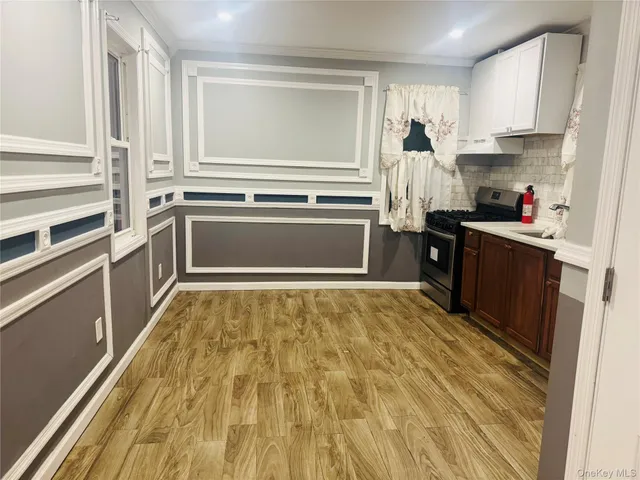 a kitchen with a stove and white cabinets