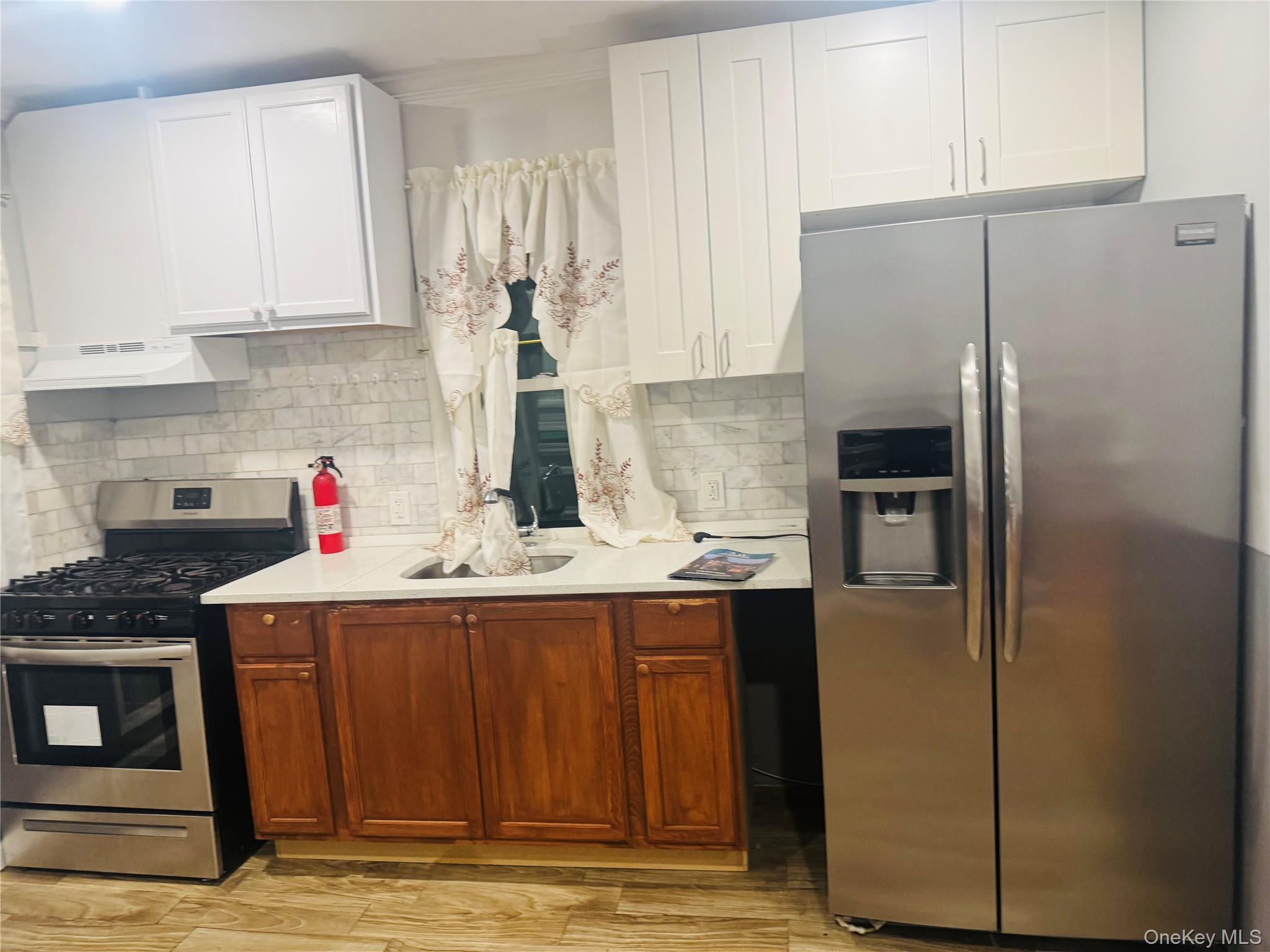 80-33 88th Road, Unit 2 Queens, NY 11421 - Photo 4 of 6 a kitchen with stainless steel appliances granite countertop a refrigerator and a stove