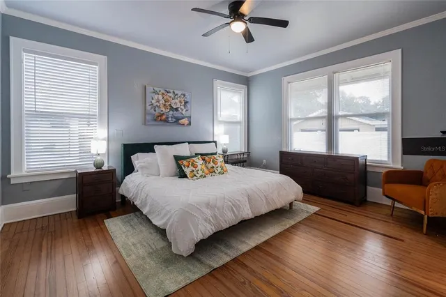 a bedroom with a large bed and a window