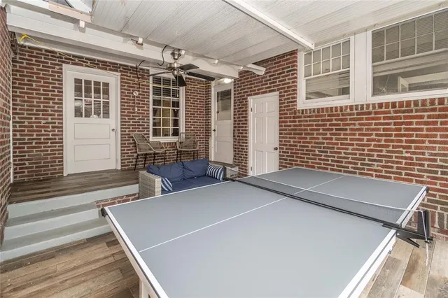 an empty room with wooden floor and ceiling fan