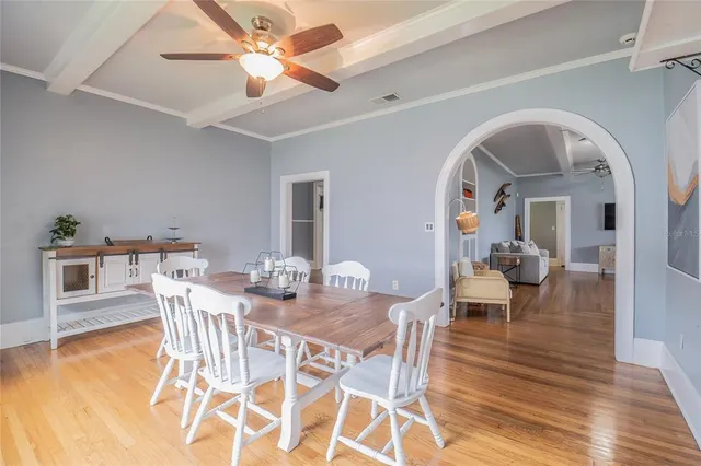 a view of a dining room with furniture and wooden floor