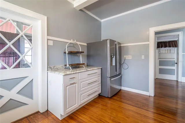 a kitchen with stainless steel appliances granite countertop a refrigerator and a stove top oven