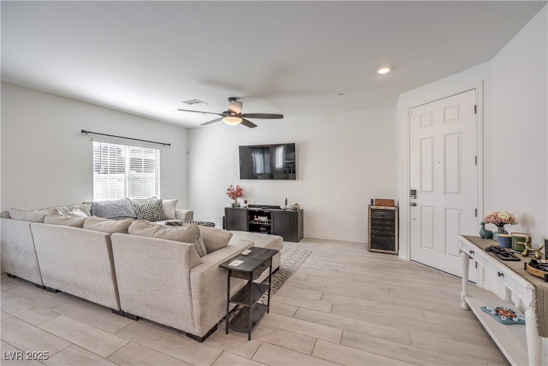 7232 North Decatur Boulevard, Unit 4 North Las Vegas, NV 89084 - Photo 4 of 36 Living room with beverage cooler, visible vents, ceiling fan, light wood-type flooring, and recessed lighting