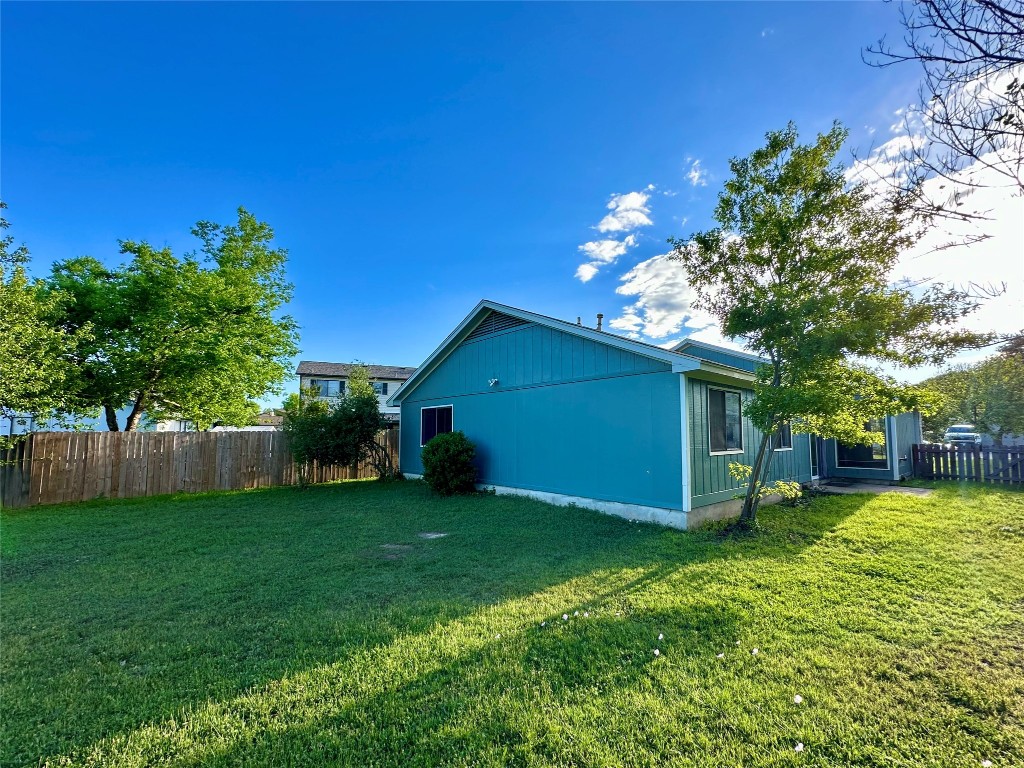 804 Brookside Pass Cedar Park, TX 78613 - Photo 13 of 15 a backyard of a house with plants and large tree
