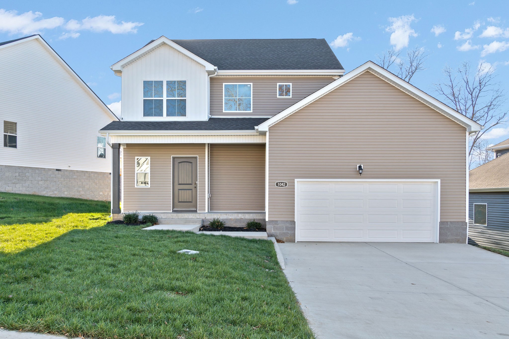 1042 Winesap Road Clarksville, TN 37040 - Photo 2 of 33 a front view of a house with a yard and garage