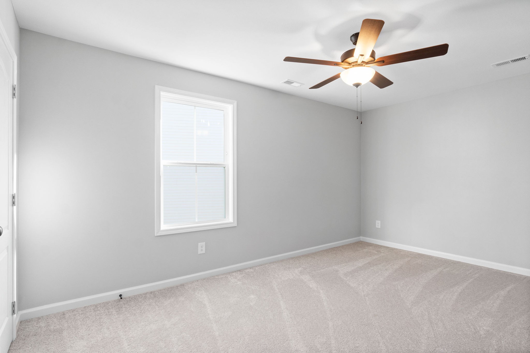 1042 Winesap Road Clarksville, TN 37040 - Photo 24 of 33 an empty room with a window and a fan